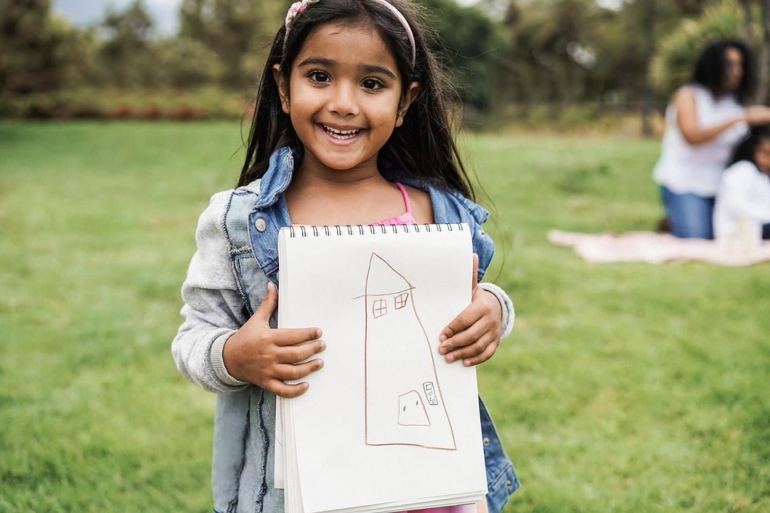 Young CBSE primary student showing a drawing during a creative arts activity