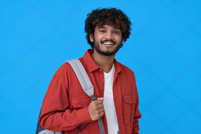 Smiling CBSE secondary school student in the UAE holding a backpack